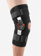 Woman wearing Flexa hinged knee brace, front view, daily wear with bilateral alloy hinge