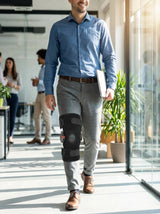Adult wearing Flexa Hinged Brace at the office, discreet under clothing for daily wear